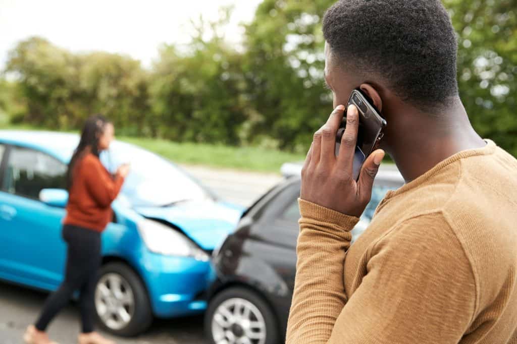 Male Motorist Involved In Car Accident Calling Insurance Company Or Recovery Service